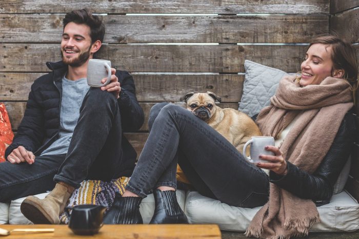 couple with a dog enjoying a cup of coffee