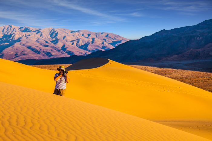man photographing a desert