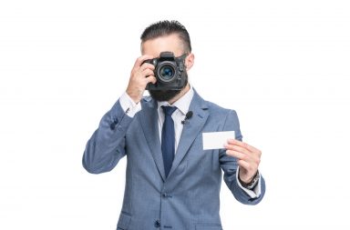 man holding one of his photography business cards