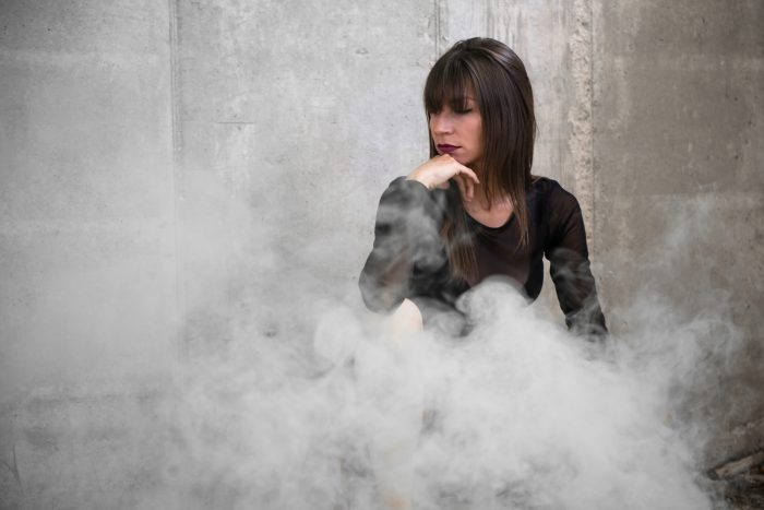 girl behind a cloud from smoke bomb photography