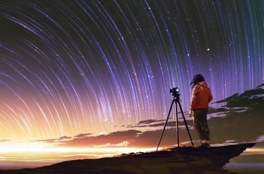 photographer taking a picture of star trails
