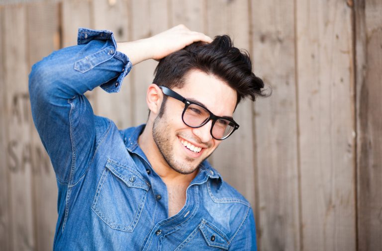 handsome young male posing and smiling outdoors