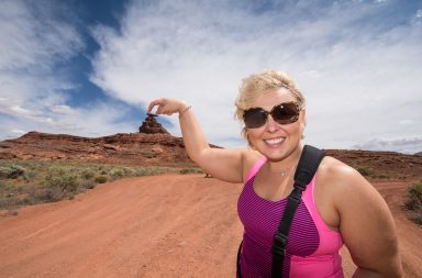 Woman shows a forced perspective view of a mountain