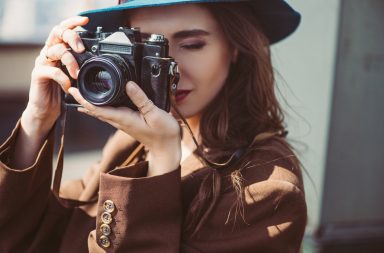 girl with a hat doing photography