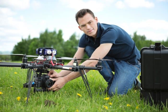 man setting up an aerial photography drone