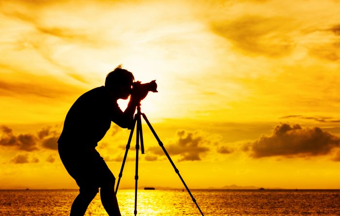 Silhouette of photographer with monopod vs tripod at sunset