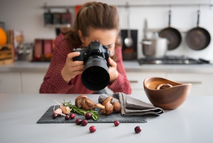 woman photographing food details with her camera