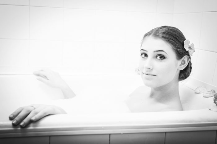 girl posing for a photo in a bathtub