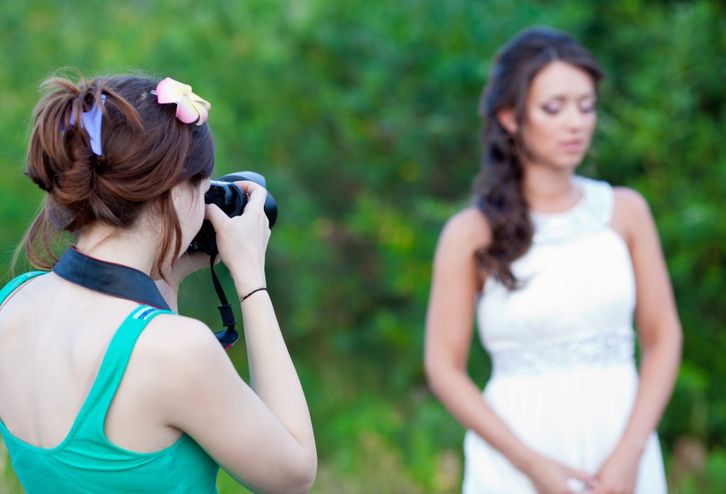 Picture of a woman photographer making a photo of a bride